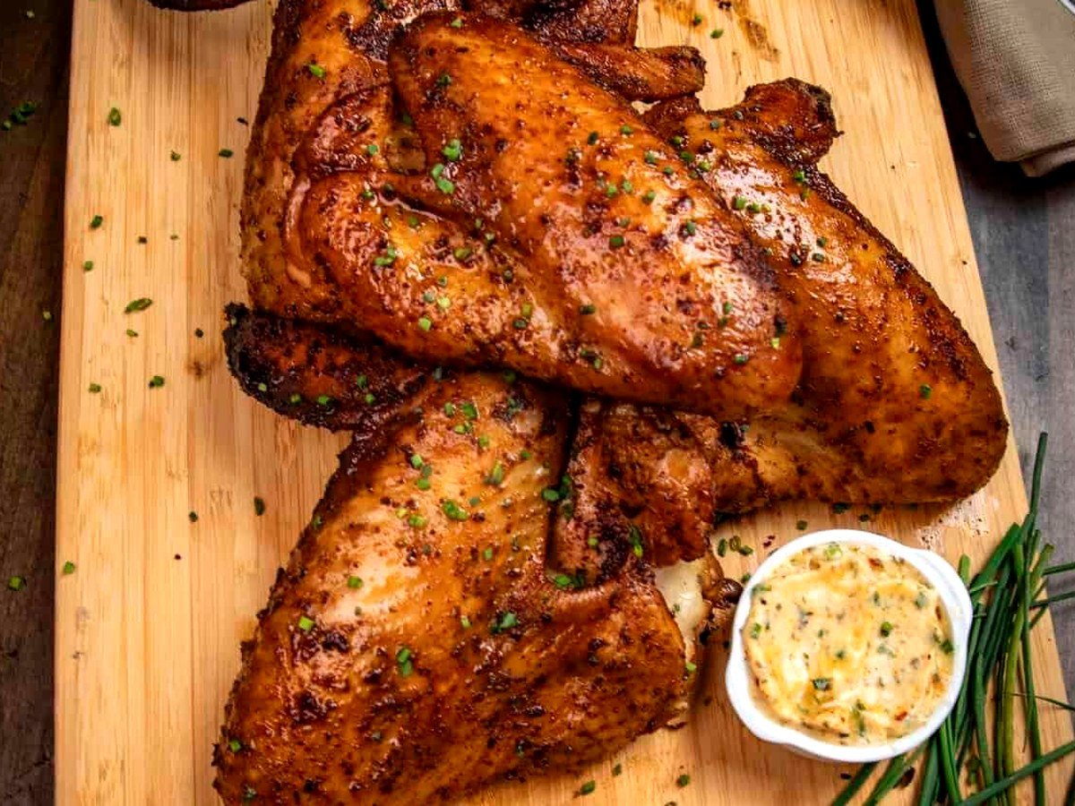 Slow-smoked turkey wings on a cutting board
