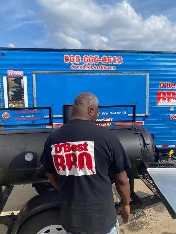 Uncle D working the smoker in his D'Best BBQ shirt