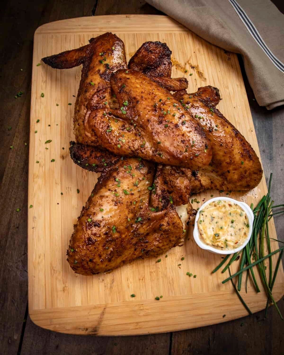 Slow-smoked turkey wings on a cutting board